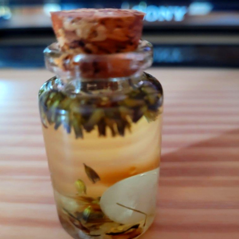 Love intention oil with rose quartz in it